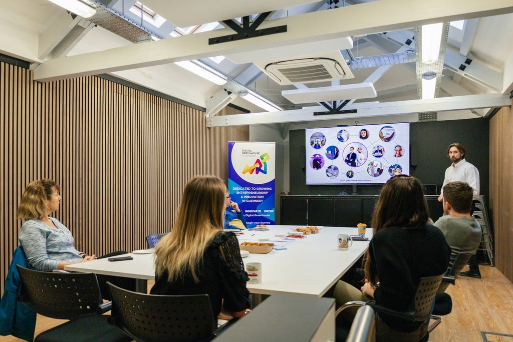 An INSO workshop with people gathered around a table at Digital Greenhouse in Guernsey.